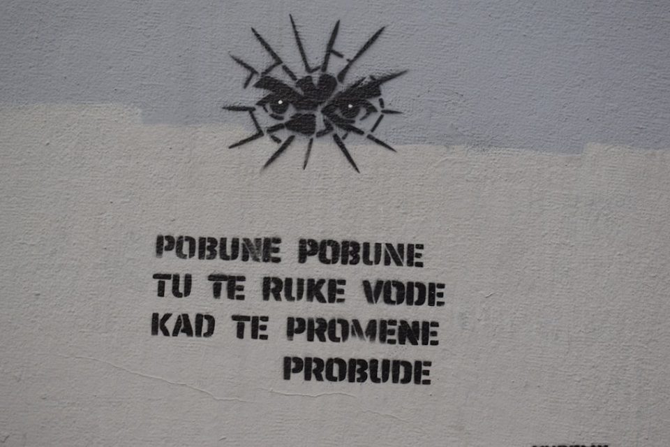 Graffiti with eyes and text on a wall